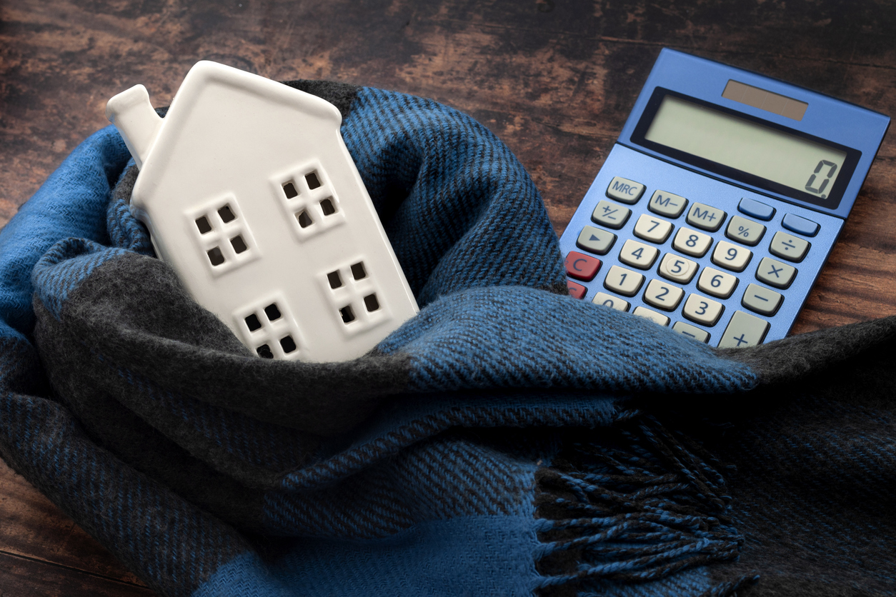 Calculator, home and scarf representing how to save money on winter heating